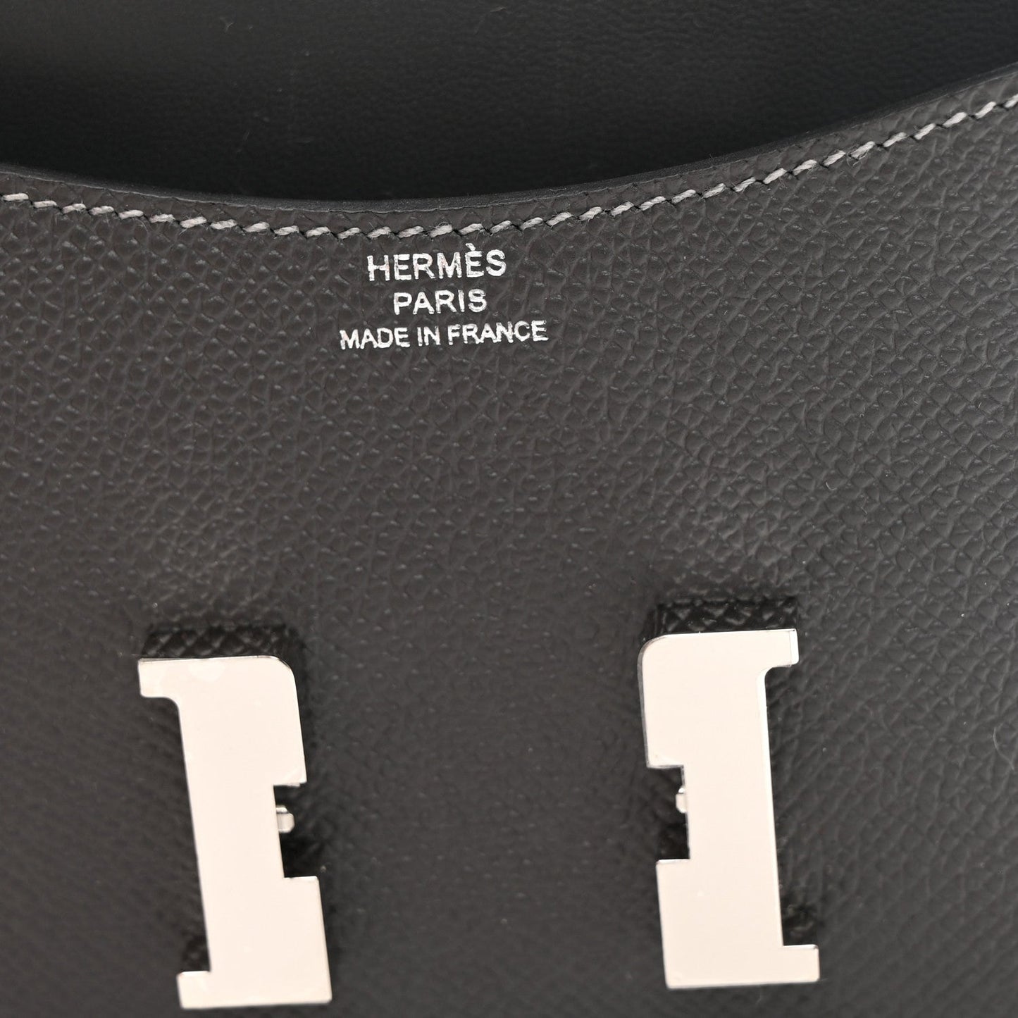 Constance slim wallet interior, dark textured leather with embossed brand text