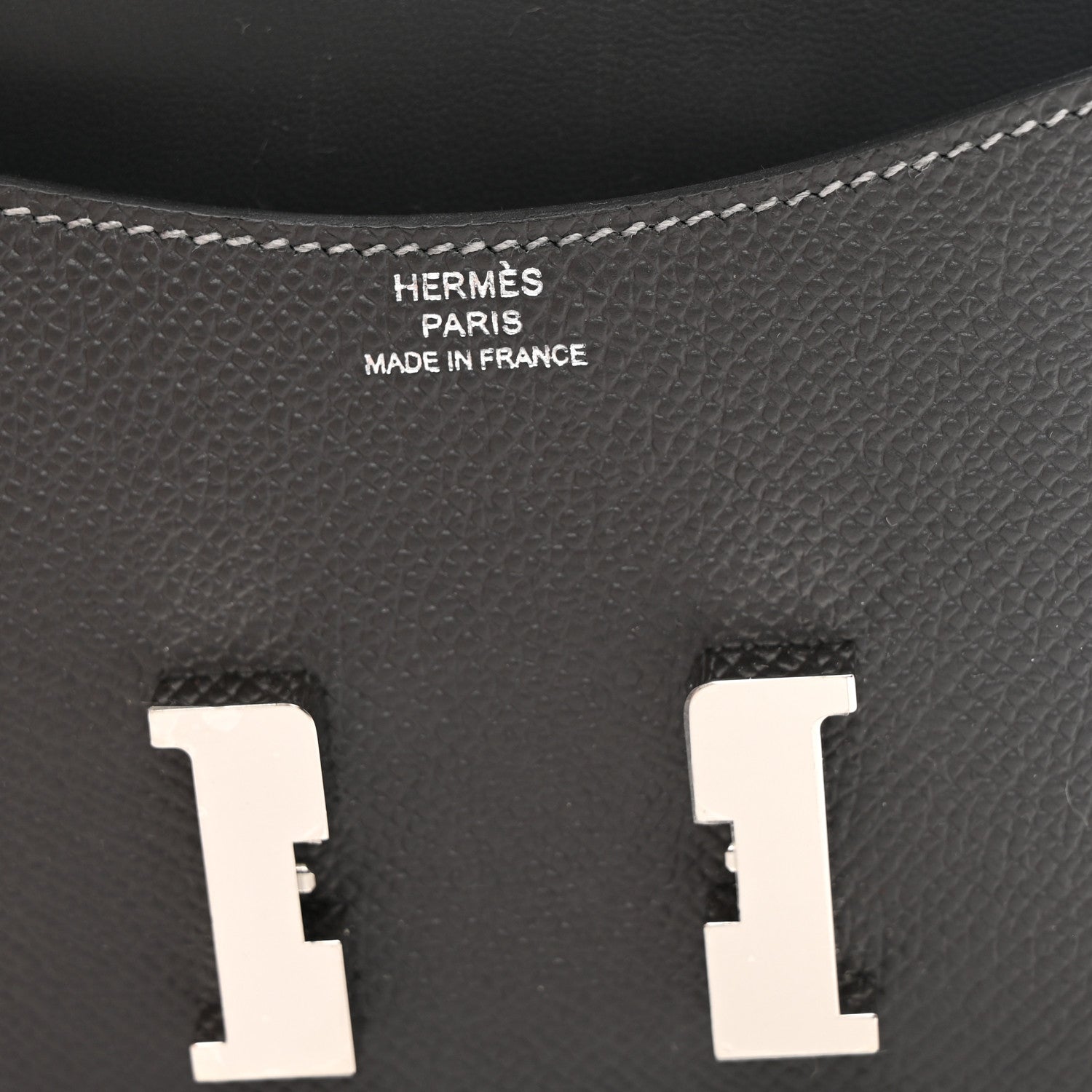Constance slim wallet interior, dark textured leather with embossed brand text