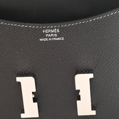 Constance slim wallet interior, dark textured leather with embossed brand text