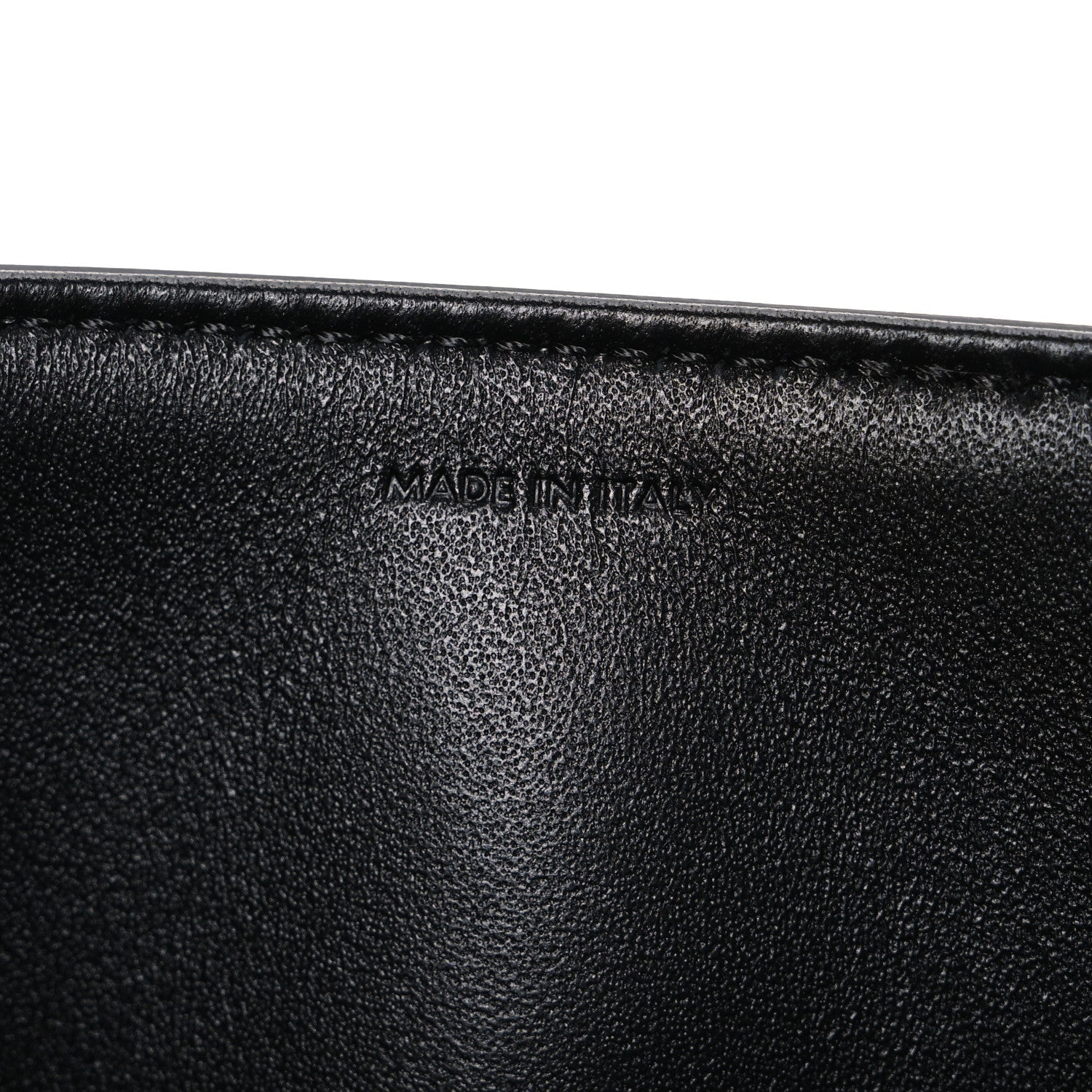 Shiny calfskin medium shoulder bag, black interior close-up with “Made in Italy” stamp