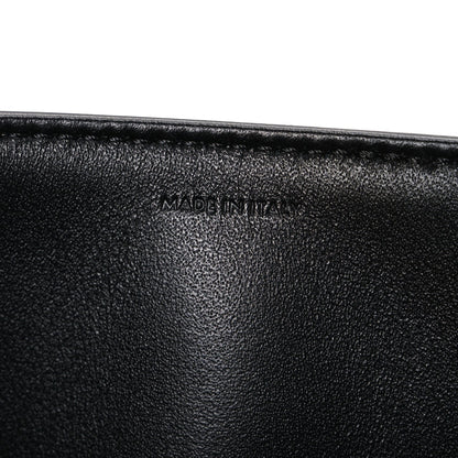 Shiny calfskin medium shoulder bag, black interior close-up with “Made in Italy” stamp
