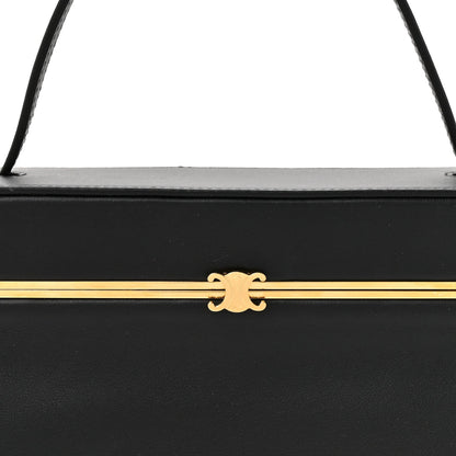 Black leather rectangle bag front latch with gold-tone bar and emblem