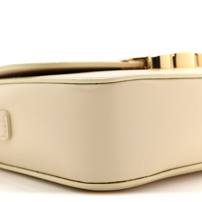 Close-up of nude calfskin edge with gold clasp bar and top trim