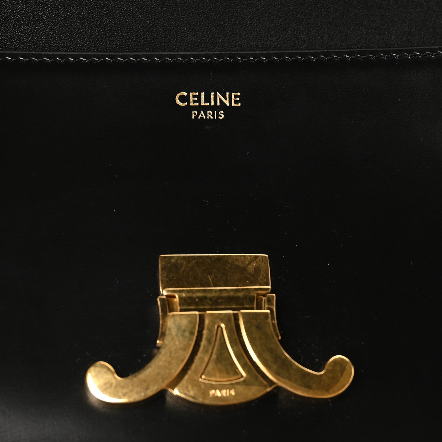 Celine Paris Triomphe gold-tone clasp detail on black leather flap