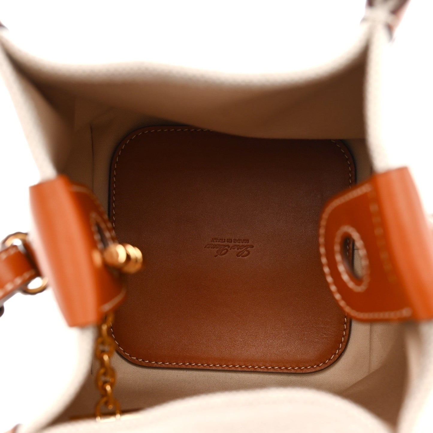Loro Piana micro bale bag interior, brown leather lining with embossed logo.