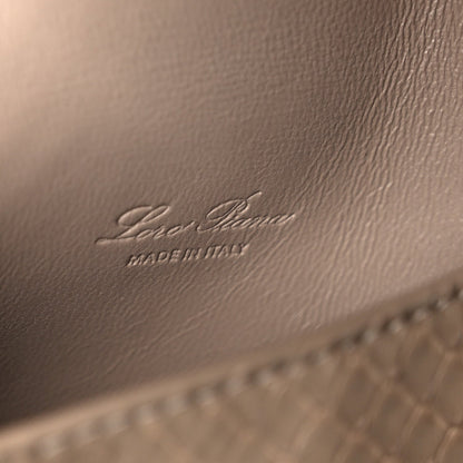 Matte snakeskin handbag close-up of embossed Loro Piana logo on front panel