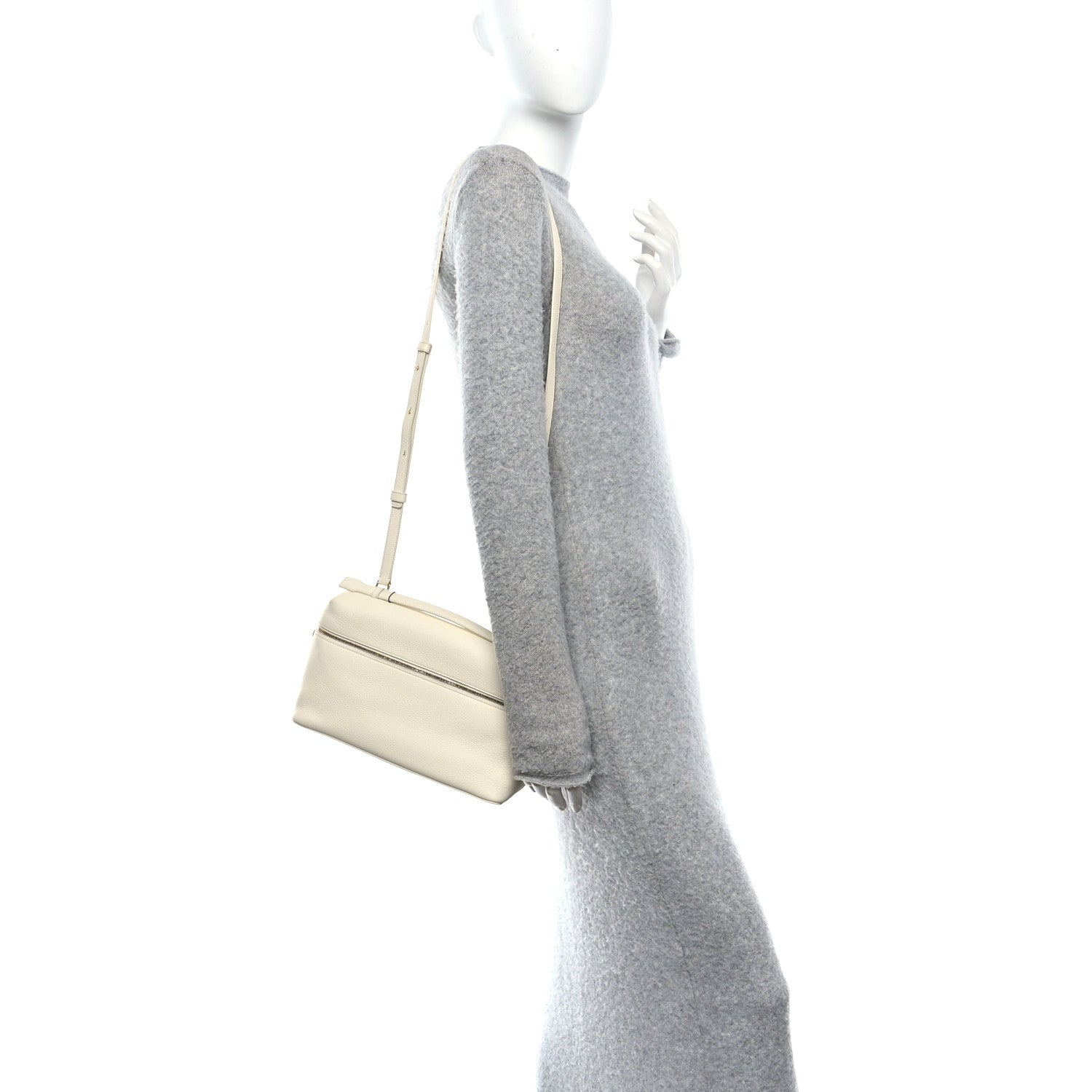 White lambskin extra pocket bag on a mannequin, with crossbody strap