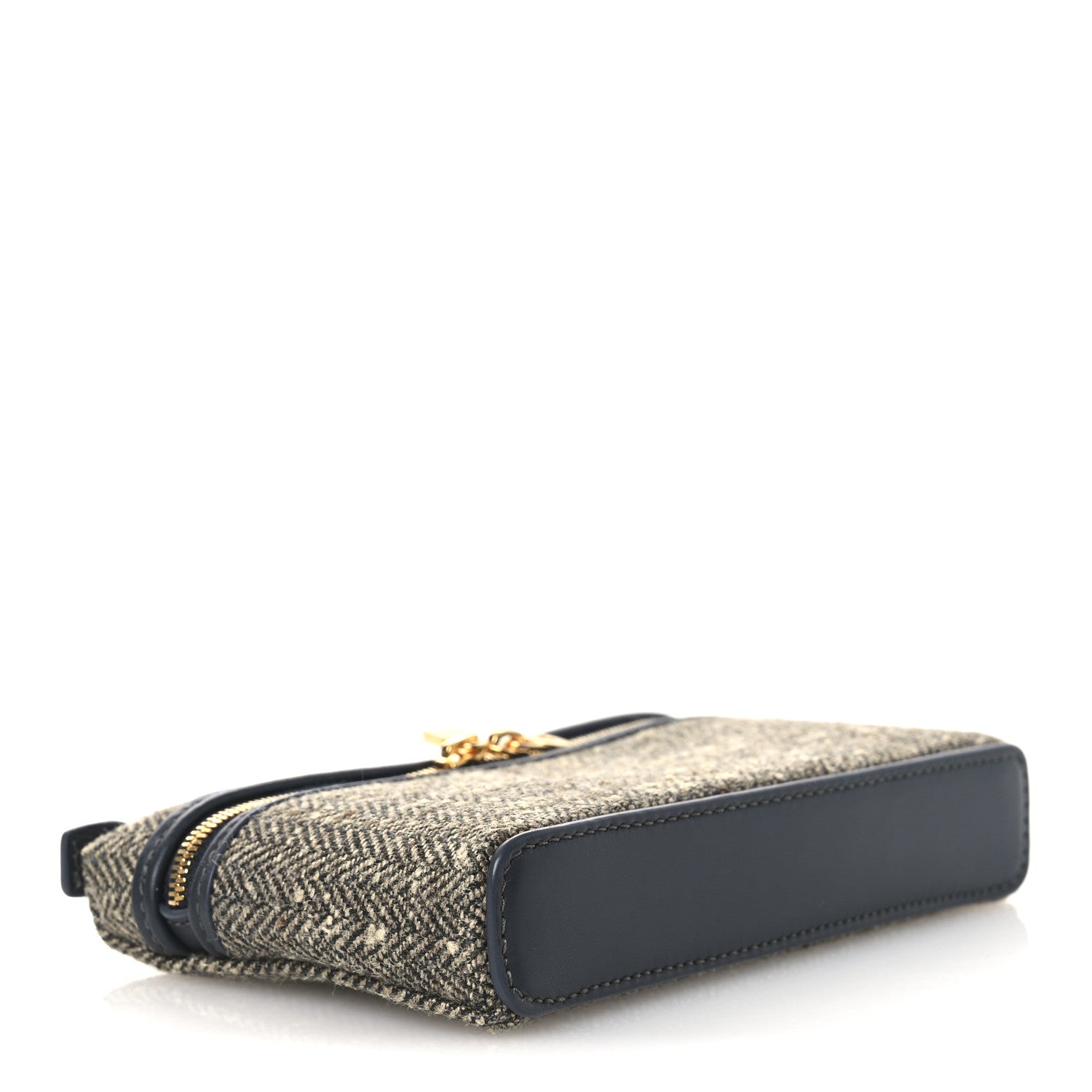 Mini herringbone pouch side view with navy leather trim and gold zipper pull