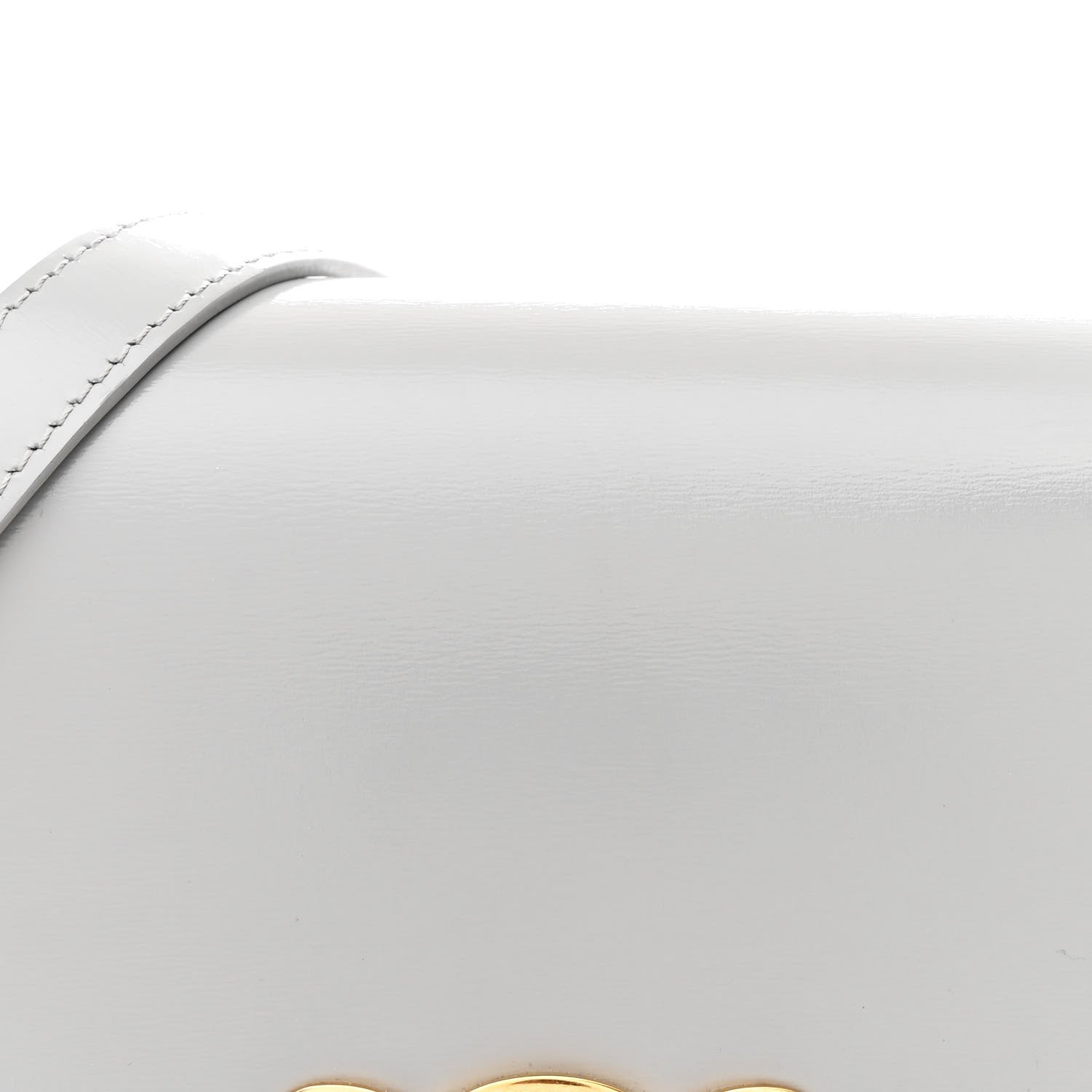 Shiny calfskin bag flap with smooth grain texture close-up