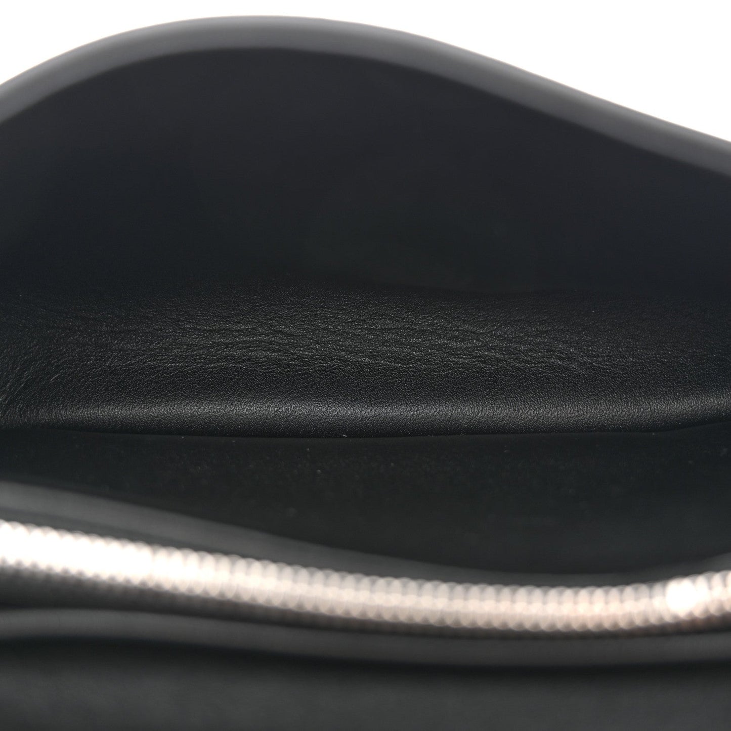 Black leather shoulder bag close-up of smooth top edge and inner lining