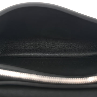 Black leather shoulder bag close-up of smooth top edge and inner lining