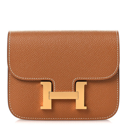 Constance slim wallet in textured tan leather with gold-tone H clasp and flap
