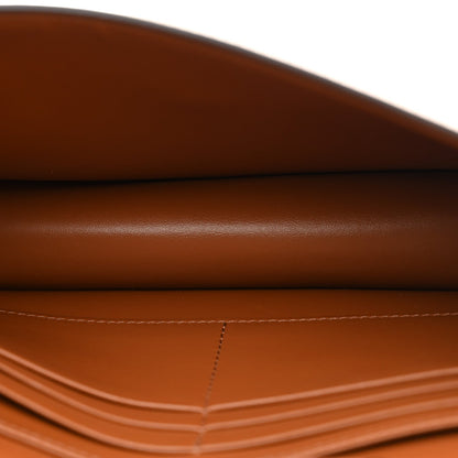 Close-up of tan/brown leather wallet surface with visible seam stitching