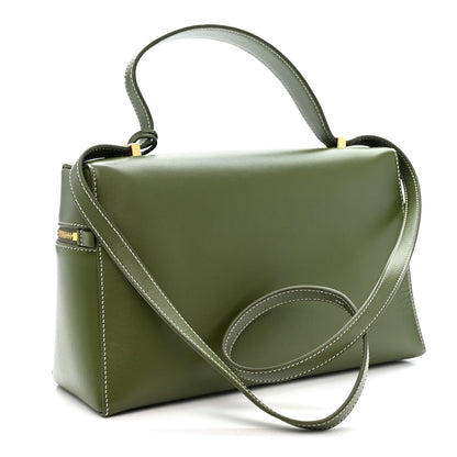 Olive green leather crossbody handbag with top handle, long strap, and front stitch panel