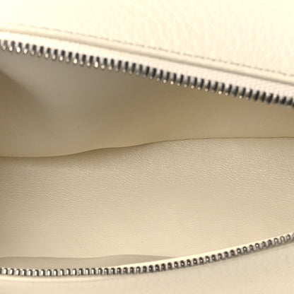 Pouch interior seam and zipper teeth along the top opening