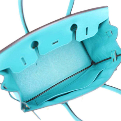 Elegant turquoise leather tote bag with spacious interior and refined, timeless design