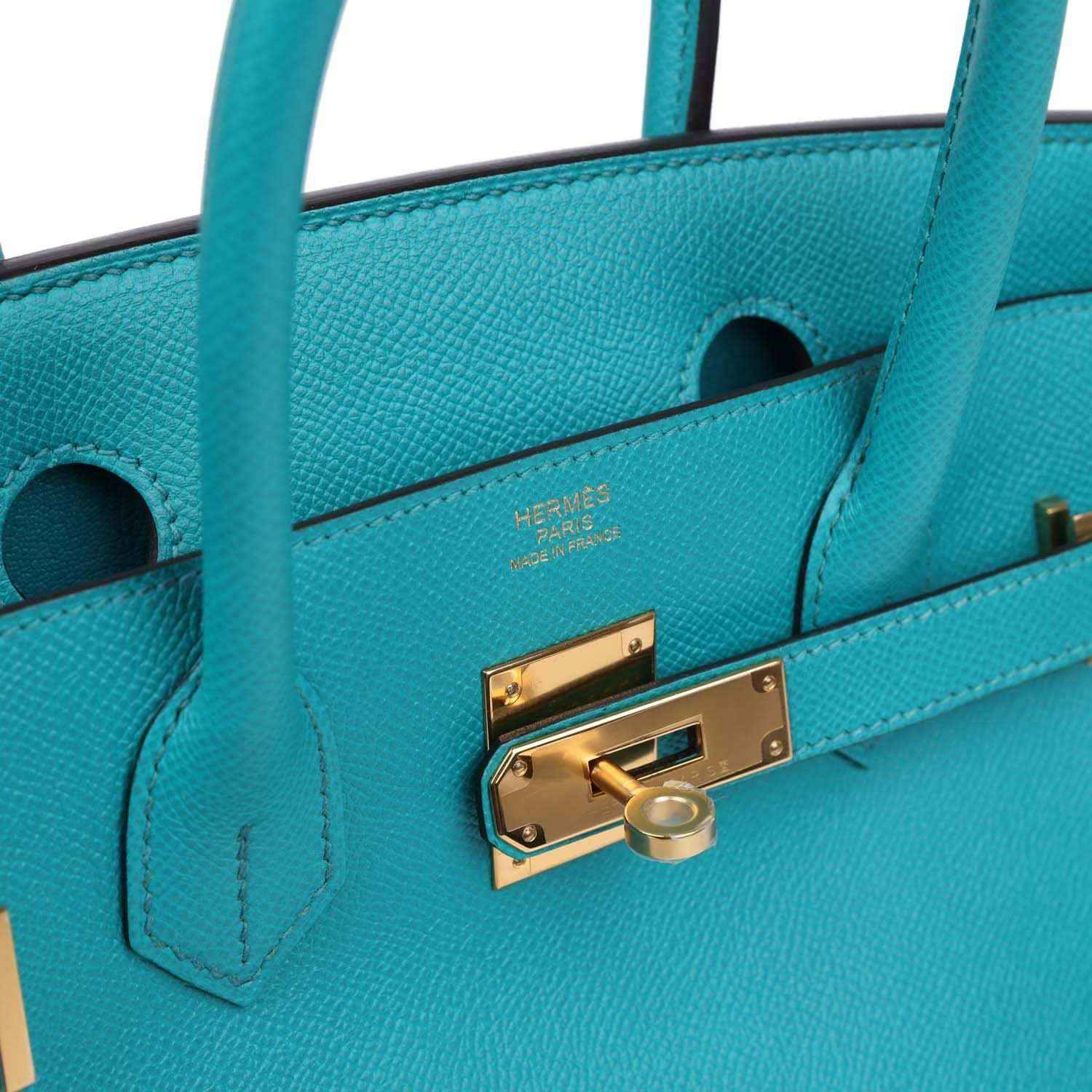 Elegant turquoise leather handbag with gold hardware, timeless and sophisticated style