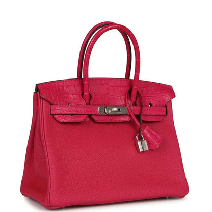 Timeless and sophisticated fuchsia leather handbag with croc-embossed details and silver lock