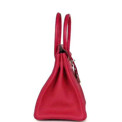 Elegant red leather handbag with a sophisticated, timeless silhouette and refined texture