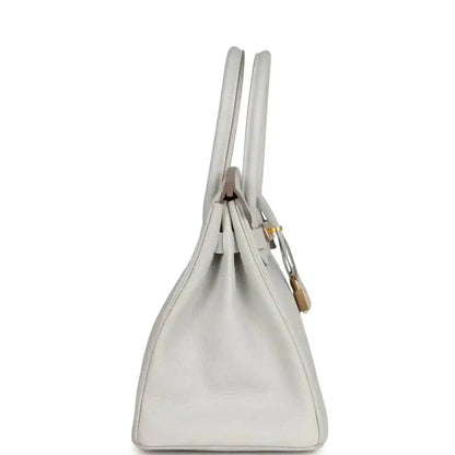 Elegant white leather handbag with gold hardware, timeless and sophisticated design