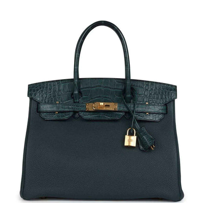 Sophisticated dark green leather handbag with crocodile texture and gold hardware, timeless elegance