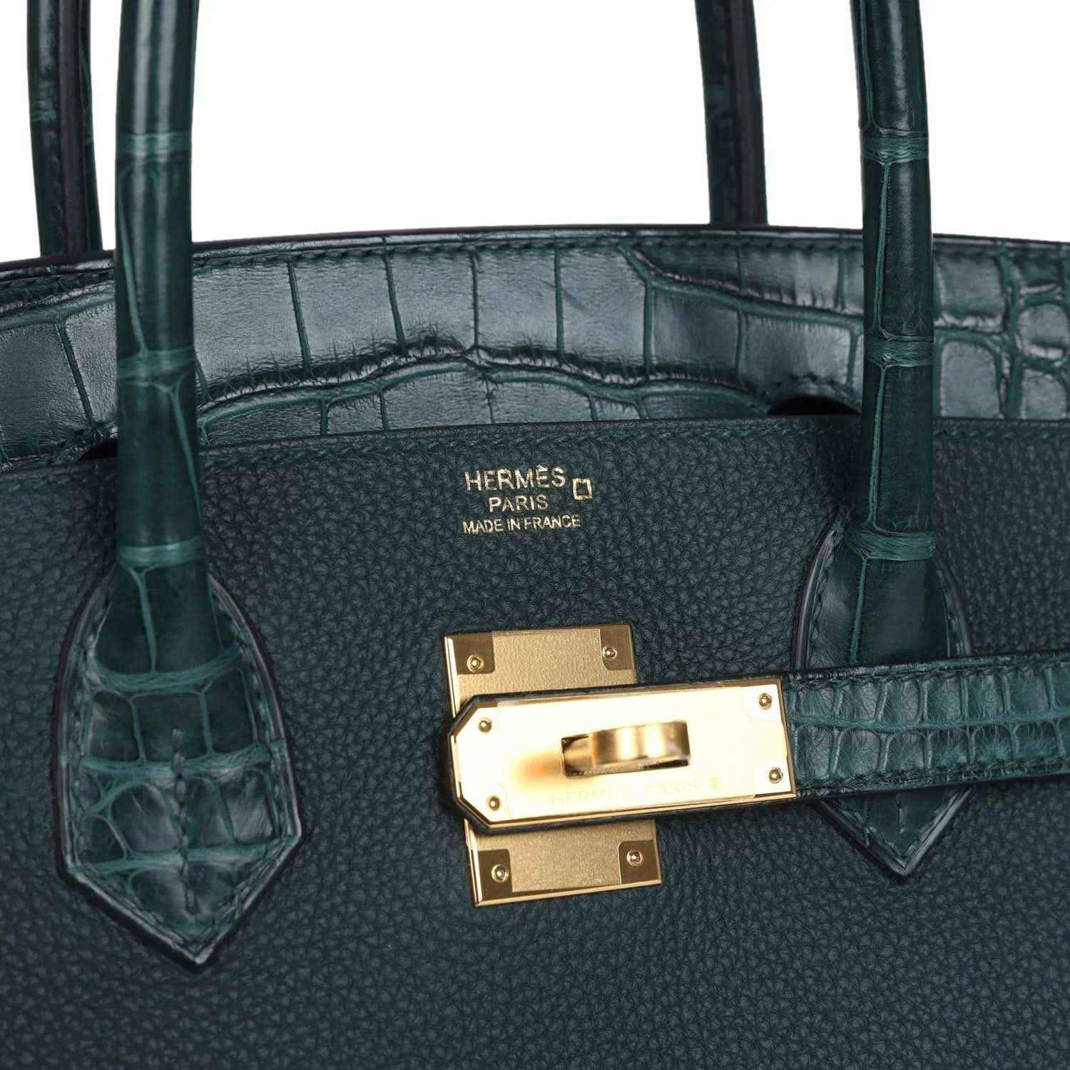 Timeless dark green leather handbag with gold hardware and elegant crocodile trim.