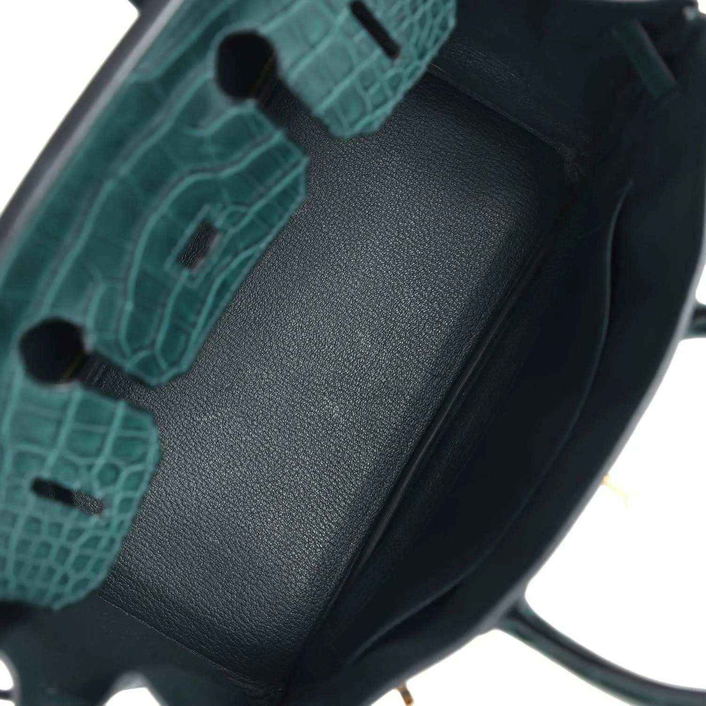 Elegant dark green leather handbag interior with refined, timeless crocodile-texture detail