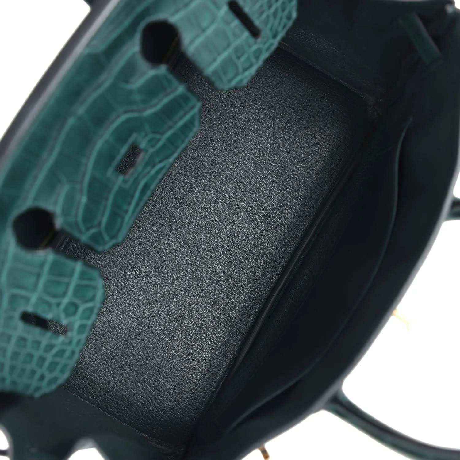 Elegant dark green leather handbag interior with refined, timeless crocodile-texture detail