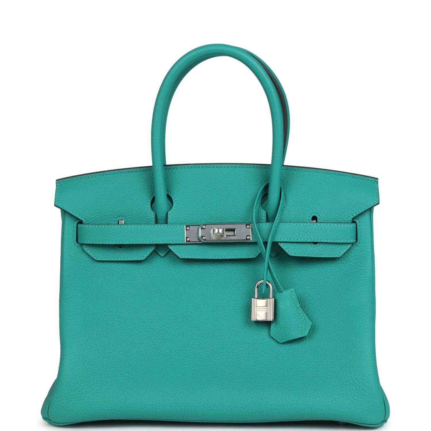Elegant turquoise leather handbag with structured silhouette and silver hardware, timeless style.