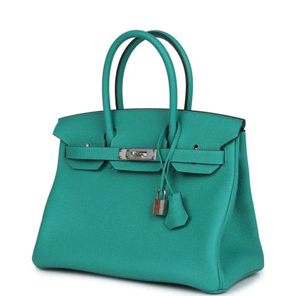 Timeless turquoise leather handbag with elegant silver hardware and classic silhouette.
