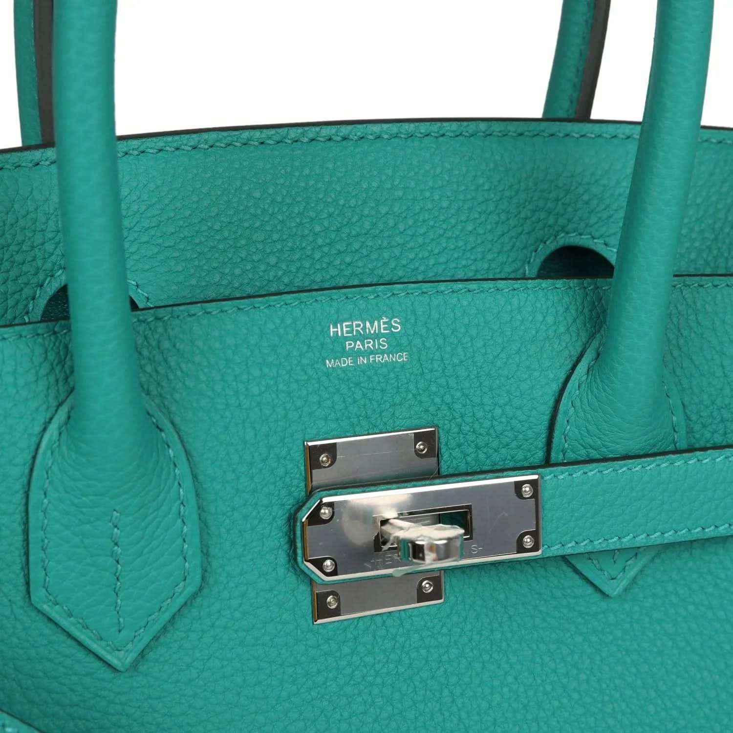 Timeless teal leather handbag with elegant silver hardware and sophisticated detailing.