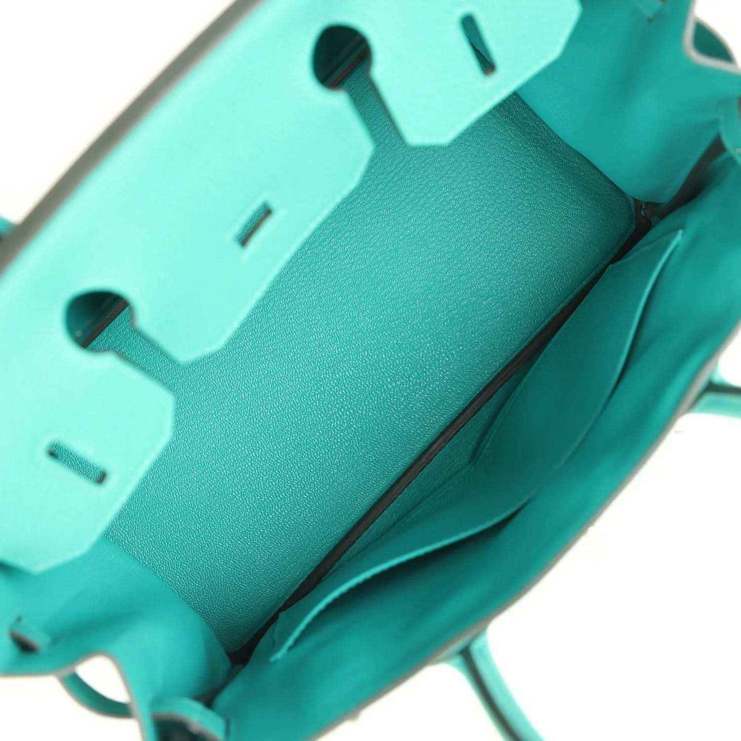 Elegant turquoise leather handbag interior, showcasing timeless and refined design.