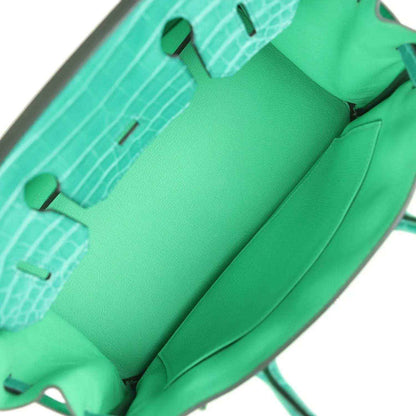 Elegant green leather tote bag interior with spacious, timeless and sophisticated design
