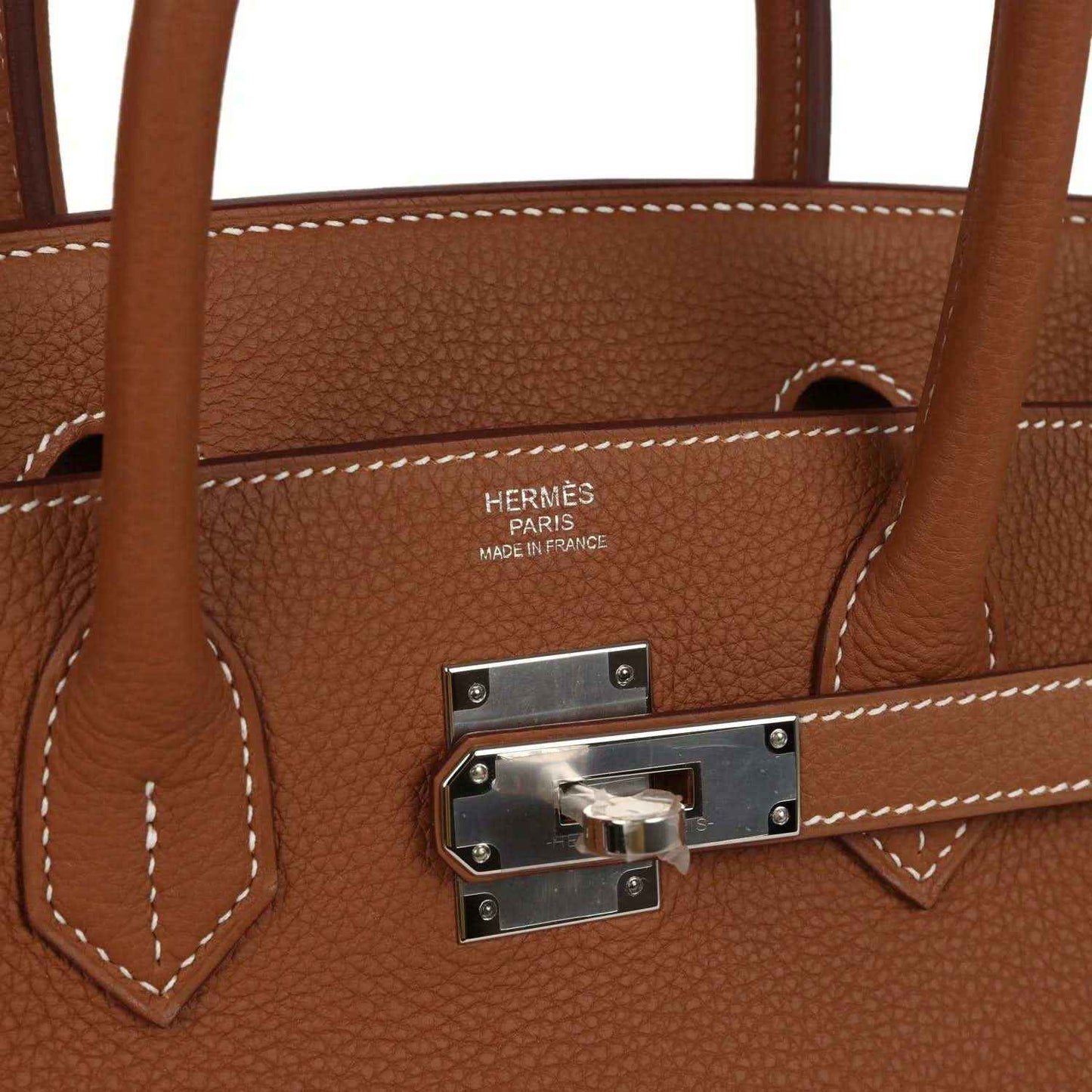 Timeless brown leather handbag with silver hardware, elegant stitching, and sophisticated design.