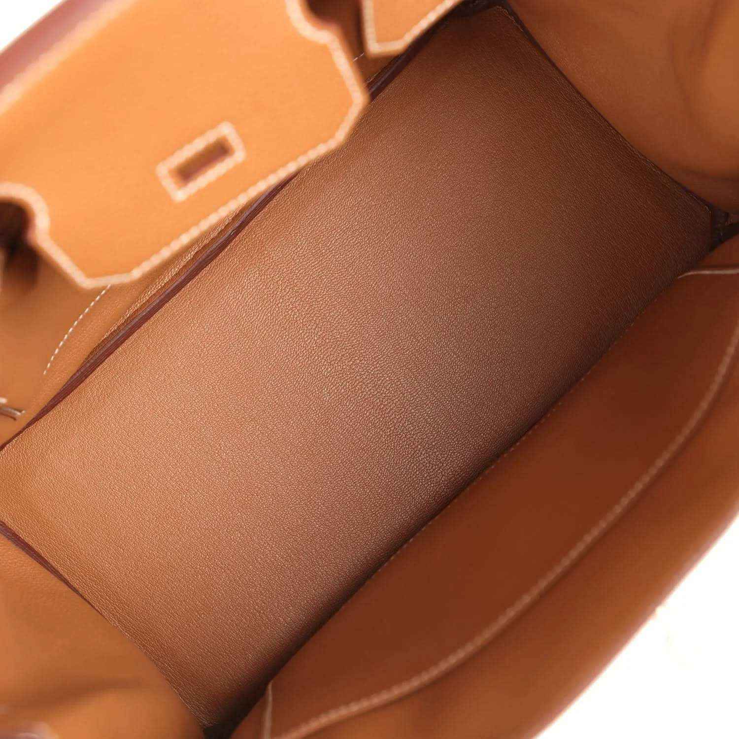 Spacious interior of a timeless tan leather handbag with elegant, refined stitching.