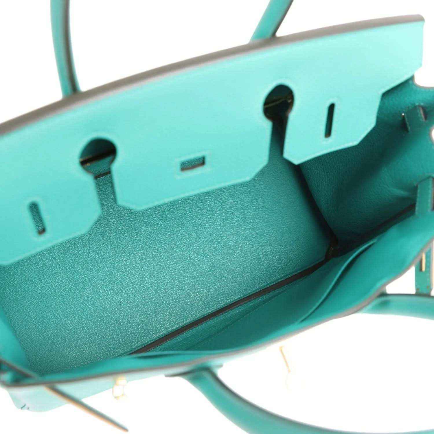 Elegant turquoise leather handbag with timeless, sophisticated interior view