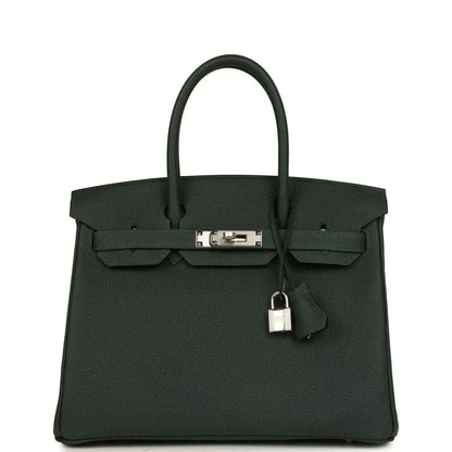 Timeless black leather handbag with silver hardware and elegant structured design.