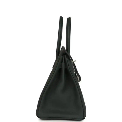 Elegant black leather handbag with a timeless, sophisticated side profile