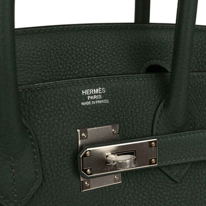 Elegant black pebbled leather handbag with silver hardware and timeless sophisticated design.