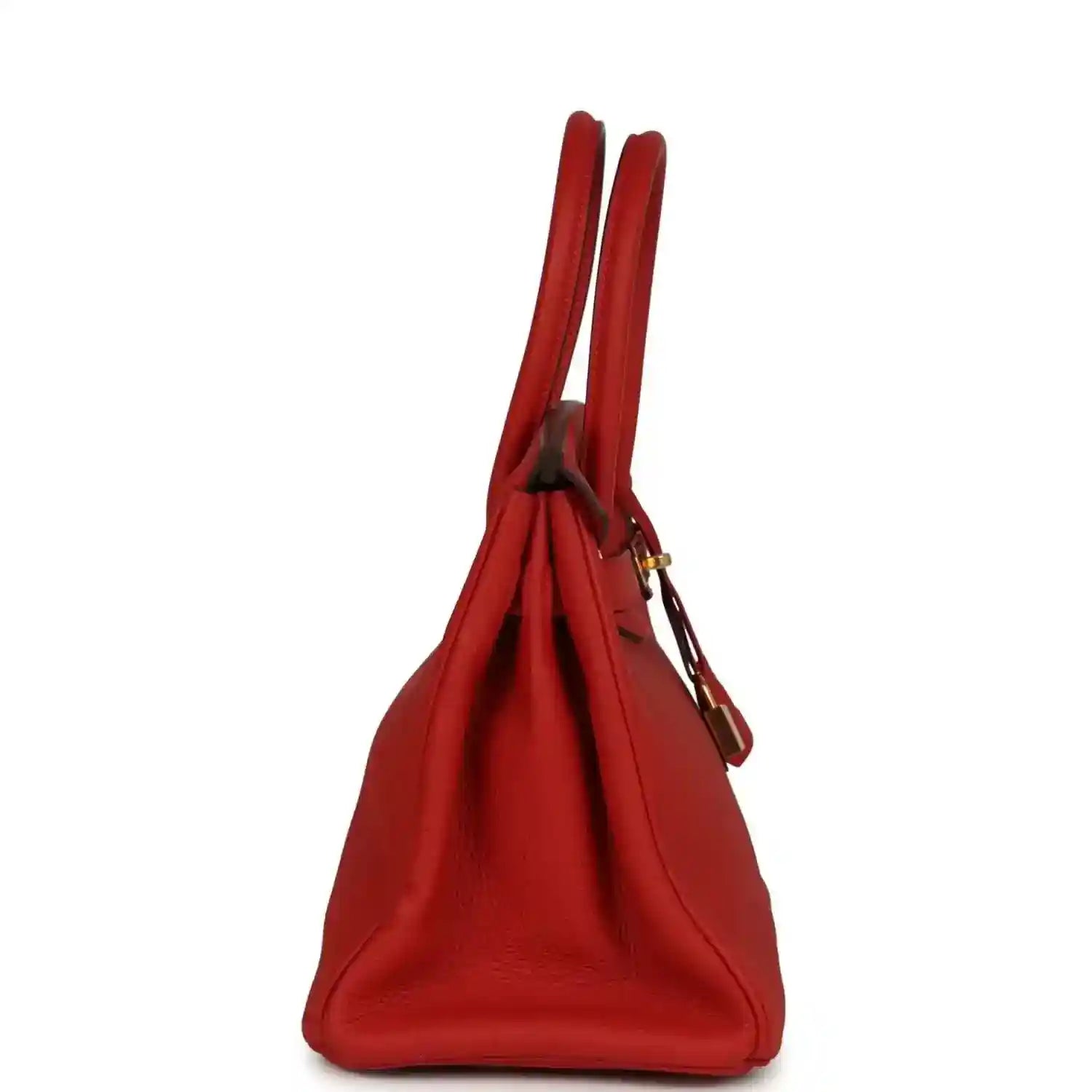 Elegant red leather handbag with gold accents, showcasing a sophisticated, timeless design.