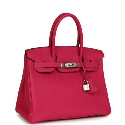 Timeless, elegant pink leather handbag with silver hardware and structured silhouette