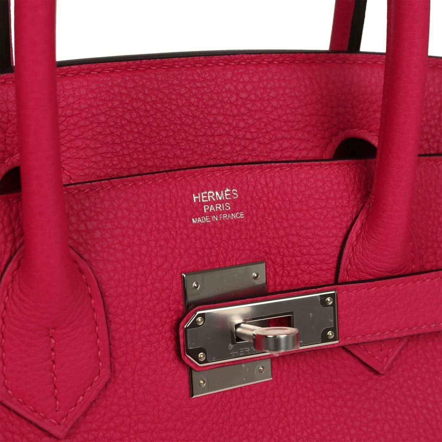 Elegant, timeless red leather handbag with silver hardware and sophisticated textured finish.