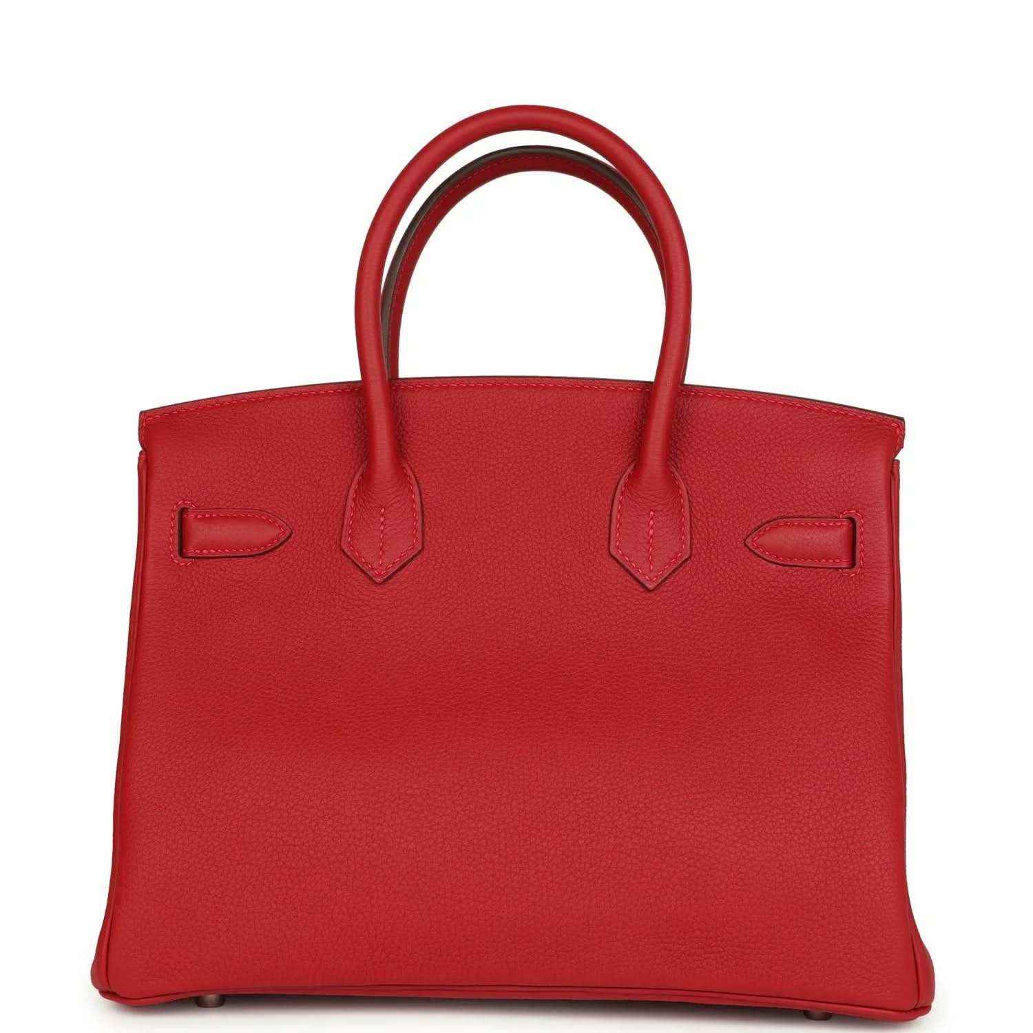 Elegant red leather handbag with top handles, timeless and sophisticated design
