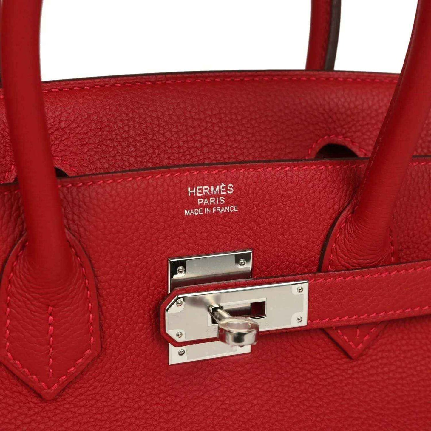 Timeless red leather handbag with elegant silver hardware and refined detailing.