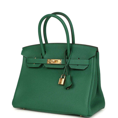 Elegant green leather handbag with gold hardware and a timeless, sophisticated design.