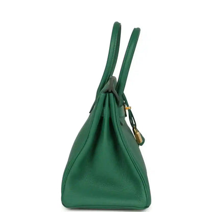 Elegant green leather handbag with gold accents, timeless and sophisticated style