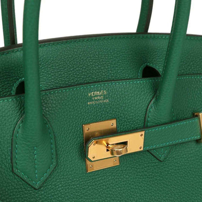 Timeless green leather handbag with gold-toned hardware and refined stitching for women