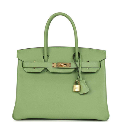 Elegant light green leather handbag with gold hardware and a timeless, sophisticated design