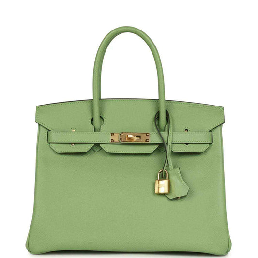 Elegant light green leather handbag with gold hardware and a timeless, sophisticated design