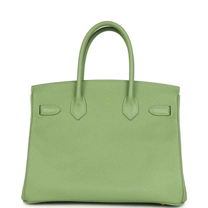 Timeless sage green leather handbag with elegant structured silhouette and top handles